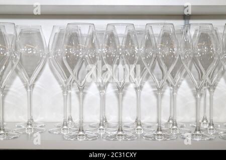 Many empty crystal glasses in restaurant cabinet Stock Photo