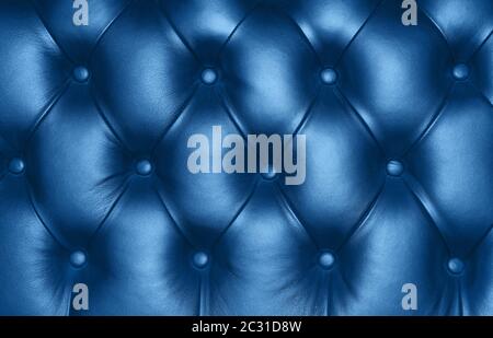 Dark blue capitone genuine leather background, classic retro Chesterfield style soft tufted furniture upholstery with deep diamond pattern and buttons Stock Photo