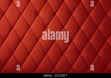 Background texture of maroon red genuine leather soft tufted furniture or wall panel upholstery with deep diamond pattern, close up Stock Photo