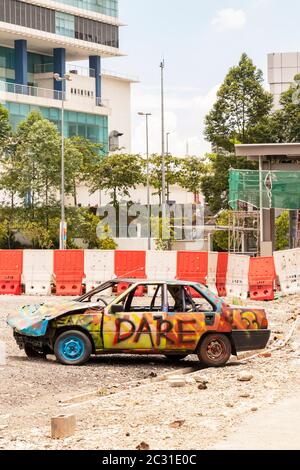 abandoned car on waste ground with graffiti in Kuala Lumpur Malaysia Stock Photo