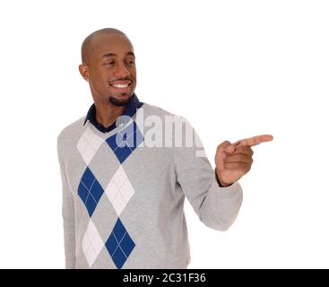 A full body image of an African American man standing in a sweater and black pants, holding his hand out, isolated for white background Stock Photo