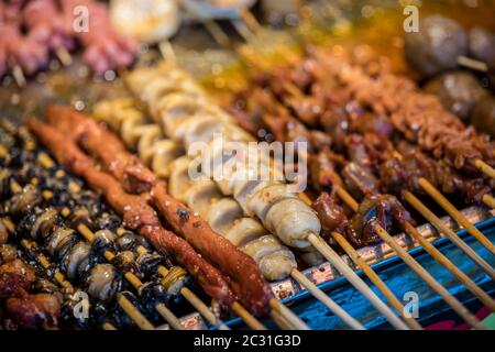 Fast food on sticks on a chinese market Stock Photo