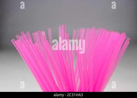 Pink plastic straws for use in soft drinks, juices, and alcoholic combinations Stock Photo