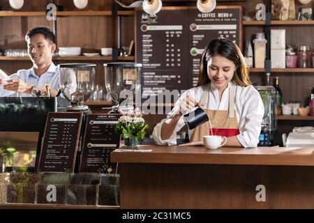 Female barista making coffee Stock Photo