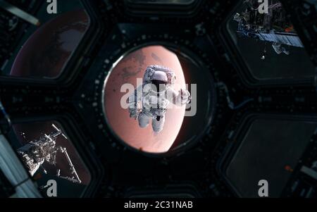 Astronaut on background of Mars. Solar system. View from porthole of spaceship. 3D Render. Science fiction Stock Photo