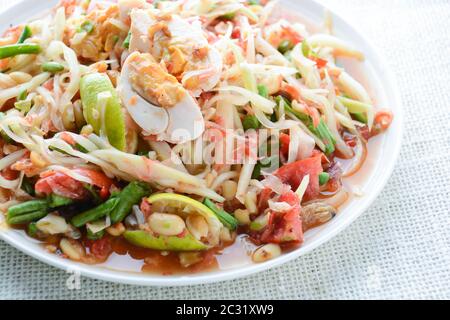 Papaya Salad with Satled Eggs, Pound chilies and garlic then place sliced tomato, eggplant and salte Stock Photo