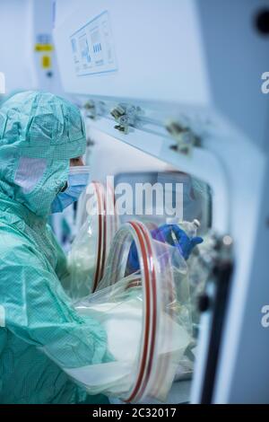 Virus antidote being prepared in a biochem lab with extremely strict precautionary measures (shallow DOF; color toned image) Stock Photo