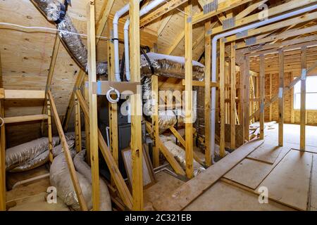 Close-up of pipes, valves close up installation of heating system on roof on stick built under home beam construction frame walls built framework home Stock Photo