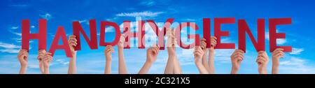 People Hands Holding Red German Word Handhygiene Means Hand Hygiene. Blue Sky As Background
