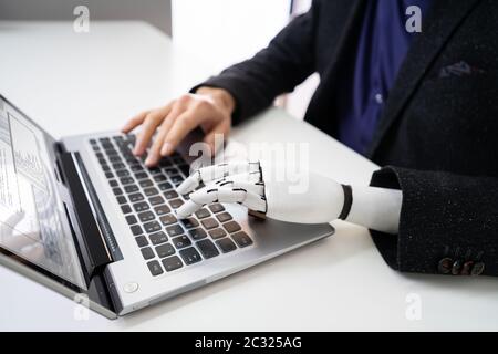 Man With Prosthetic Hand Working On Laptop. Artificial Limb Stock Photo