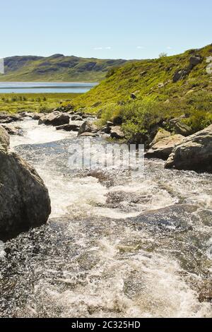 Beautiful Storebottåne river flows into the vavatn lake. Summer landscape in Hemsedal, Buskerud, Norway. Stock Photo