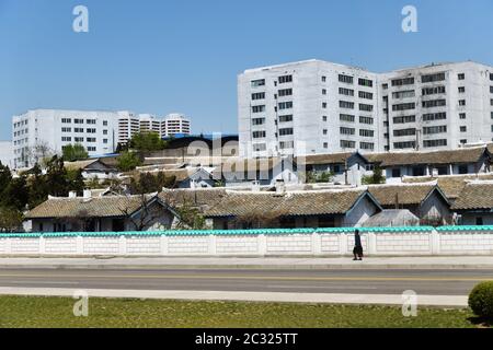 Pyongyang, North Korea - May 2, 2019: View of a typical Pyongyang outskirts, modern apartment buildings and old folk-style cottages Stock Photo