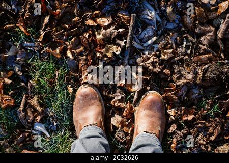 Top view on a pair of male winter shoes in autumn. Seasonal change and activity concept. Stock Photo
