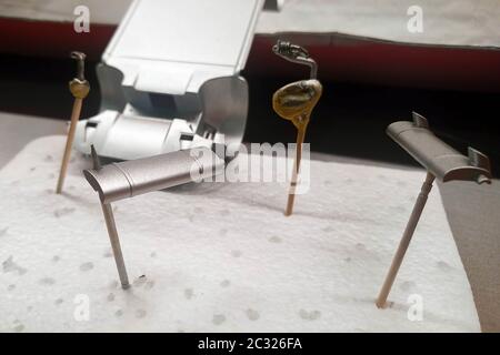 Unprimed and primed parts of a scale model car for assembly. Painted by spray exhaust system. Scale cars modeling. Stock Photo