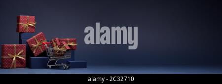 Composition with blue geometric figures, shopping trolley and red gift boxes with golden ribbon on dark blue background with copy space. Christmas. Ne Stock Photo