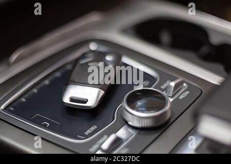 Key lies in the car on the touch panel control. Salon premium car with keyless access. Stock Photo
