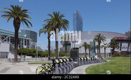 A row of Metro bikes parked in front of the Staples Center and Convention Center in downtown Los Angeles Stock Photo