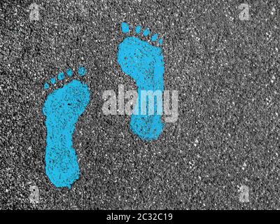Green footprints on asphalt Stock Photo