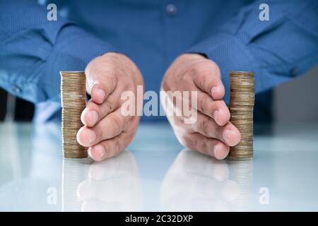 Close-up Of A Person's Hand Holding Stack Of Coins Stock Photo