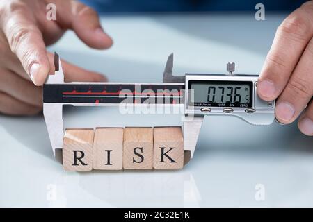 Close-up A Person's Hand Measuring Wooden Risk Blocks With Digital Electronic Vernier Caliper Stock Photo