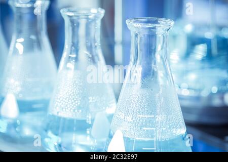 Glassware chemical test tube with chemical solution on blue tone color background Stock Photo