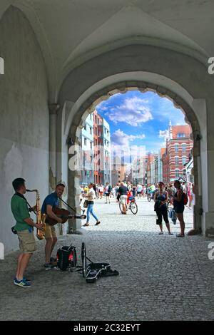 Musicians earn their living by playing guitar and saxophone in Gdansk Stock Photo