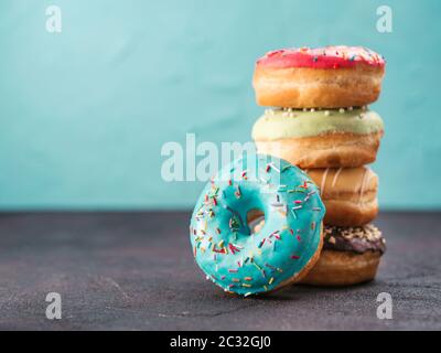 Stack of assorted donuts, copy space Stock Photo