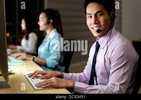 Call Center working hard at night. Stock Photo