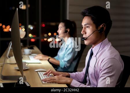 Call Center working hard at night. Stock Photo