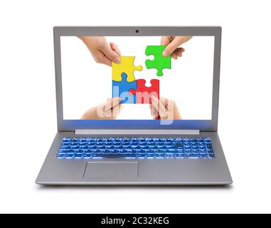 Hands and puzzle in computer notebook Stock Photo