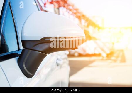 rear view mirror cover with surround view 360 degrees camera. On a white premium SUV. Parked on the street. Parking assistant and car help systems Stock Photo