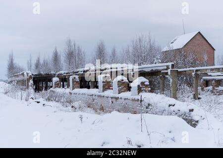 Terrible and scary abandoned farm house in winter period Stock Photo
