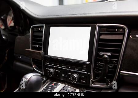Leather interior of premium luxury car. LSD Monitor of multimedia system with white screen, carbon inserts, aluminum panels, gearbox Stock Photo