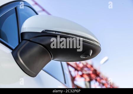 Rear view mirror cover with surround view 360 degrees camera. view from down On a white premium SUV. Parked on the street. Parking assistant and car help systems Stock Photo