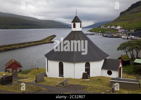 The octagonal church with a view of the Atlantic in the small town of Haldarsvik, Faeroeer, Denmark Stock Photo