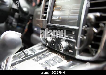 Button bar with multimedia device in a premium German sedan. headunit with sim card connector Stock Photo