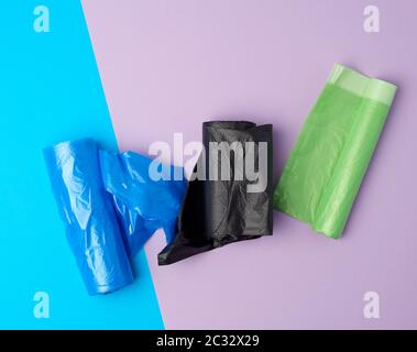 rolled up rolls with plastic garbage bags on a blue background Stock Photo