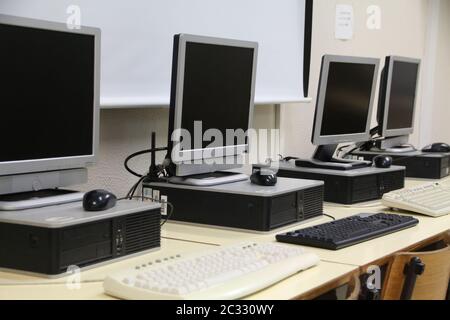 View of the interior of a classroom with row of computers on middle school. Stock Photo