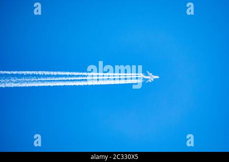 long trail of jet plane on blue sky. Aircraft on blue sky, Travel concept Stock Photo