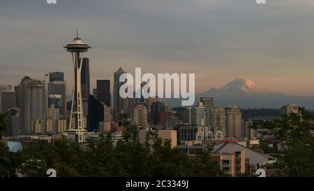 the space needle and mount rainier in seattle at sunset
