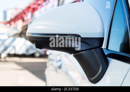 Left side. rear view mirror cover with surround view 360 degrees camera. On a white premium SUV. Parked on the street. Parking assistant and car help systems Stock Photo