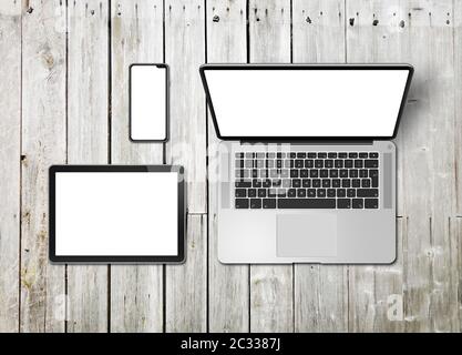Laptop, tablet and phone set mockup on a wooden desk background. 3D render Stock Photo