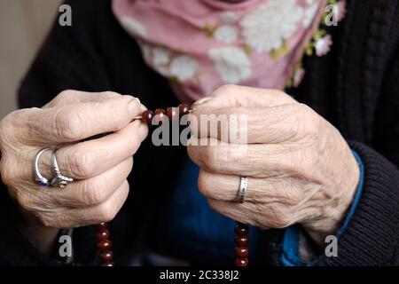 muslim old woman is worshiping with rosary, old woman and rosary in hand, Stock Photo