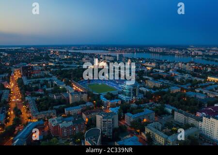Voronezh city center in evening with stadium, roads and many buildings, aerial view. Stock Photo
