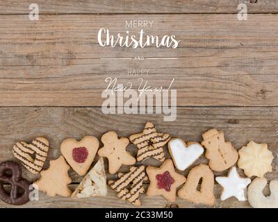 many different christmas cookies on wooden background Stock Photo