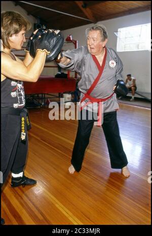 Actor Macdonald Carey best known for his role in long running soap opera Days of Our Lives in fitness/ martial arts  training session with coach Benny Urquidez. Stock Photo