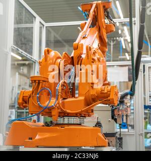 robot arms in the factory performs precise work according to the specified program. Stock Photo