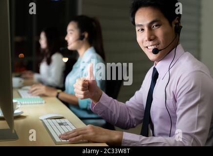 Call Center working hard at night. Stock Photo