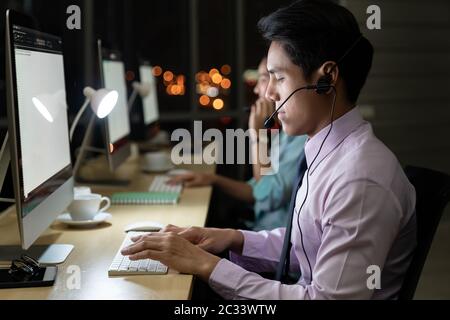 Call Center working hard at night. Stock Photo