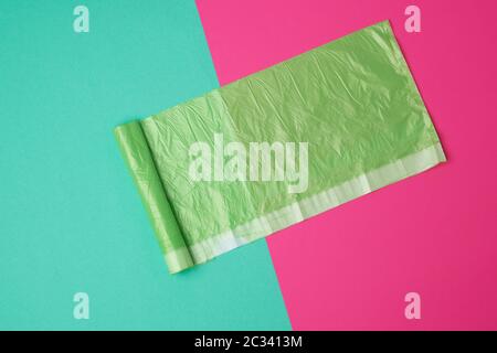 green transparent plastic bag for garbage on a colored background, top view Stock Photo